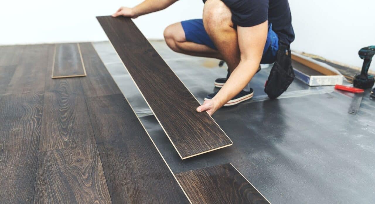 A man installing lvp flooring.