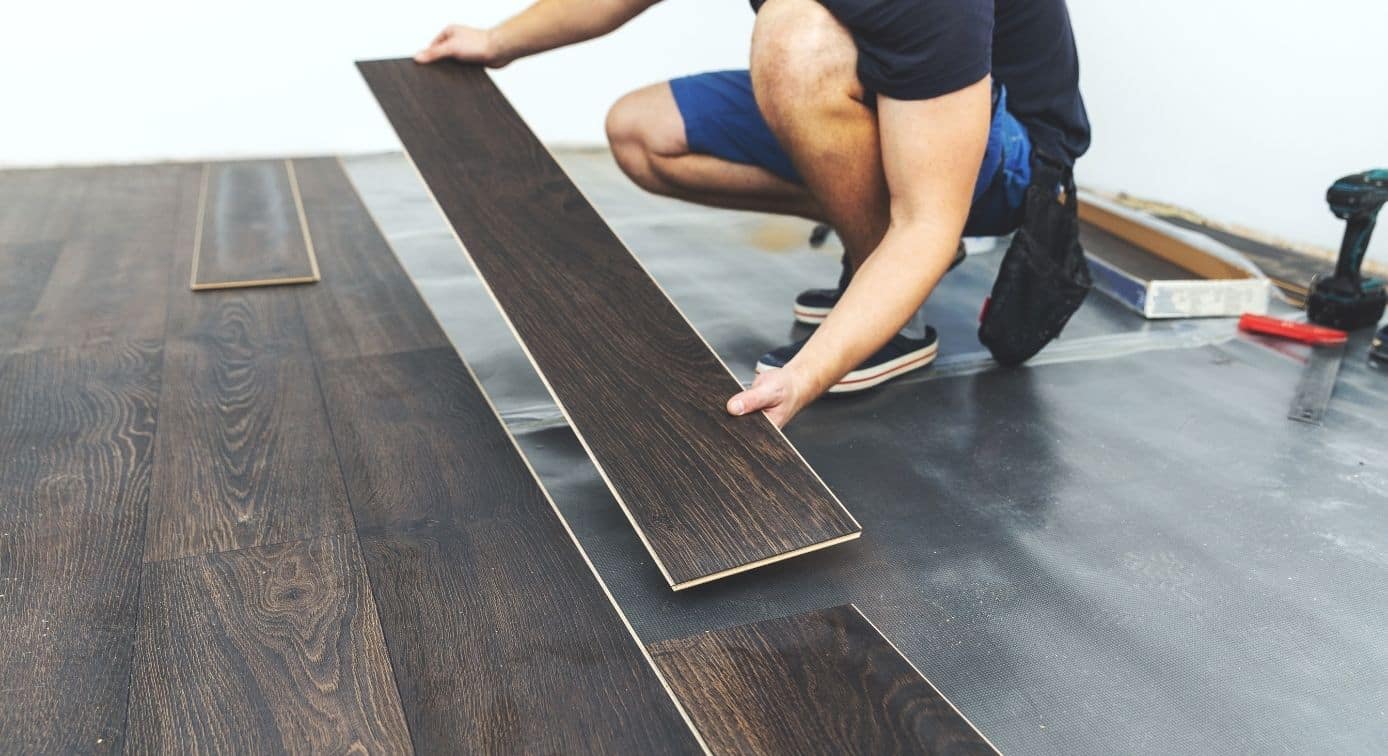 A man installing lvp flooring.