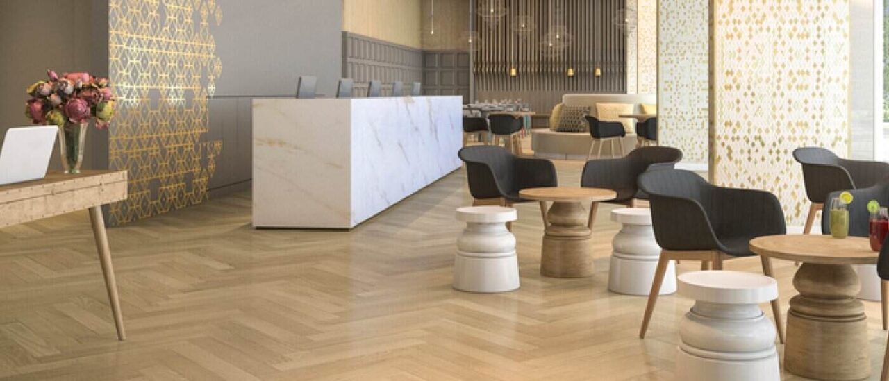 Modern commercial space with elegant LVP flooring, stylish seating, and a marble reception desk embodying beauty and heavy duty performance.