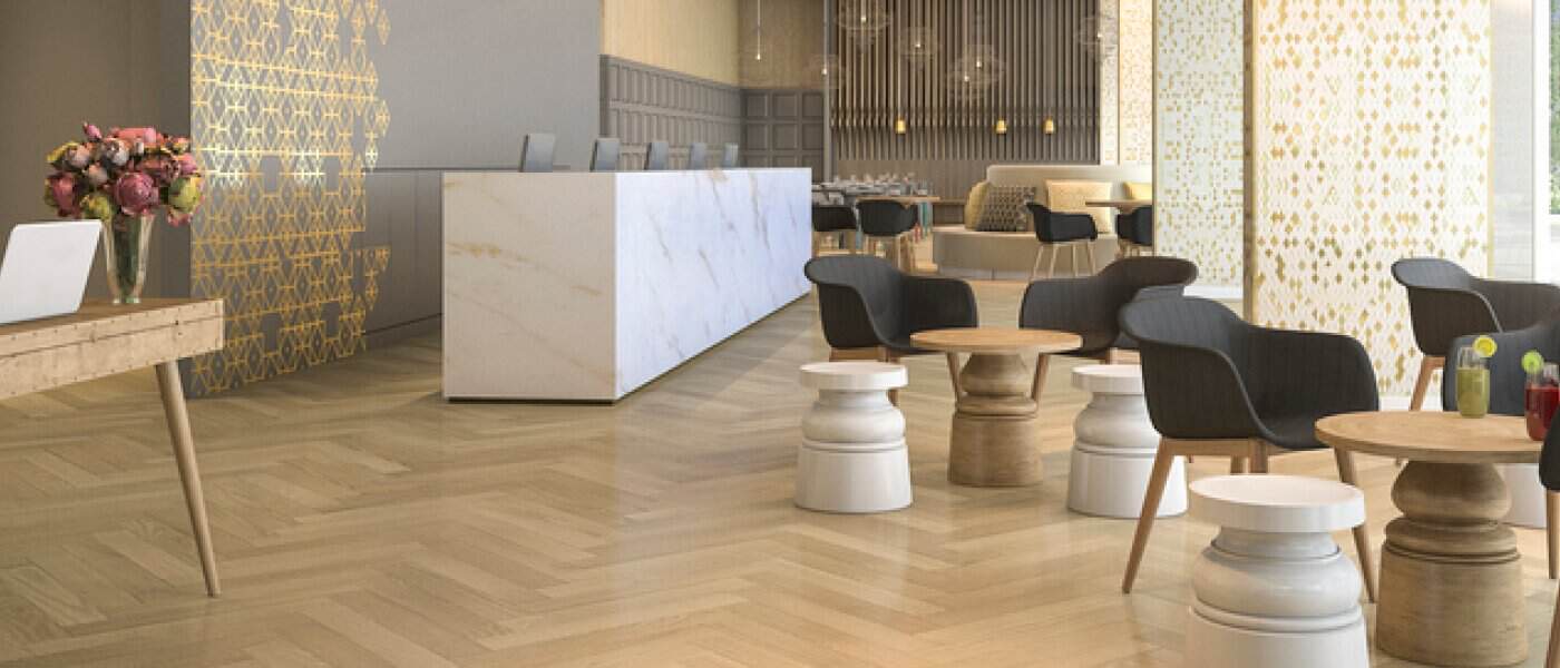 Modern commercial space with elegant LVP flooring, stylish seating, and a marble reception desk embodying beauty and heavy duty performance.